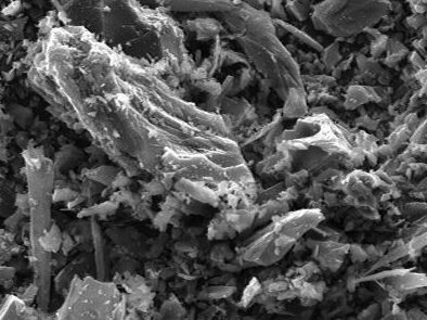 Scanning electron microscope image showing a close-up view of mineral particles and fragments, highlighting their intricate textures and structures at a magnification of 250x.