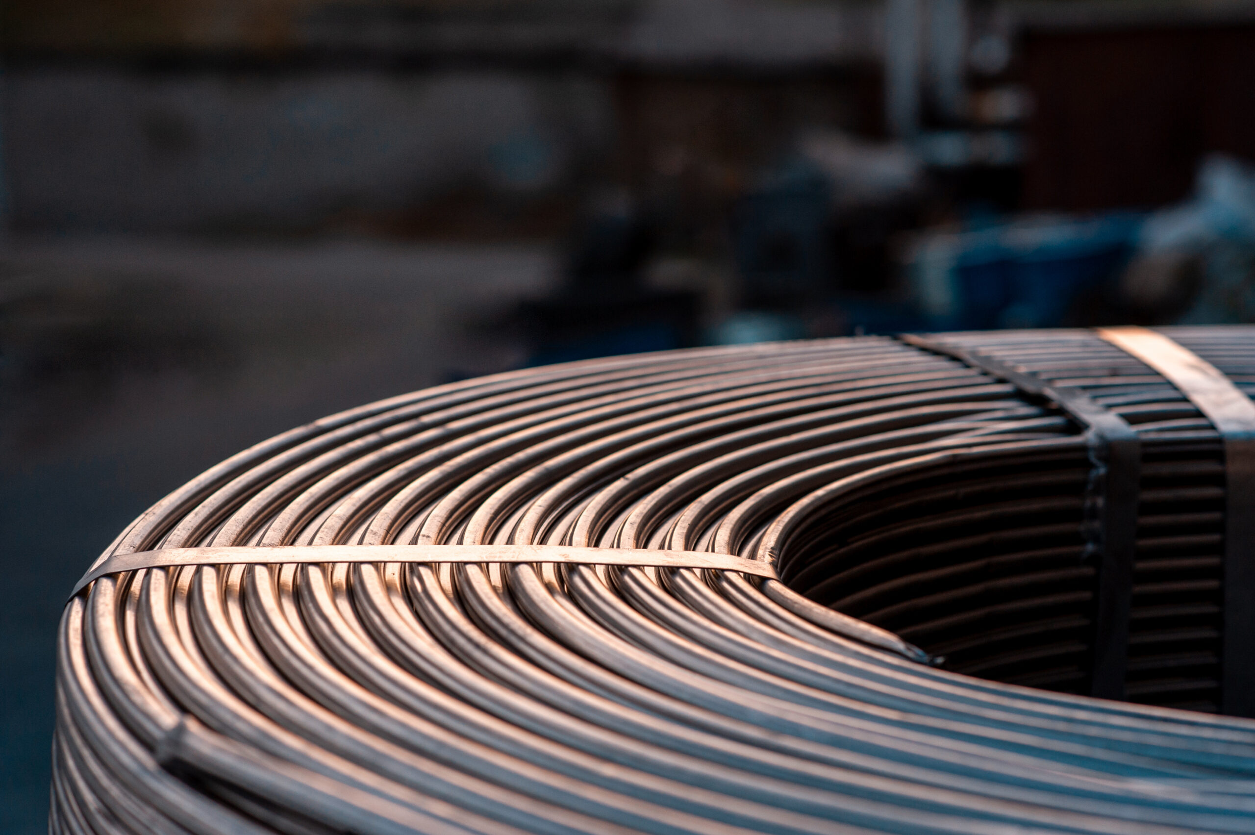 Close-up of a coiled steel wire roll, showcasing its smooth metallic surface and circular shape, commonly used in construction and manufacturing applications.