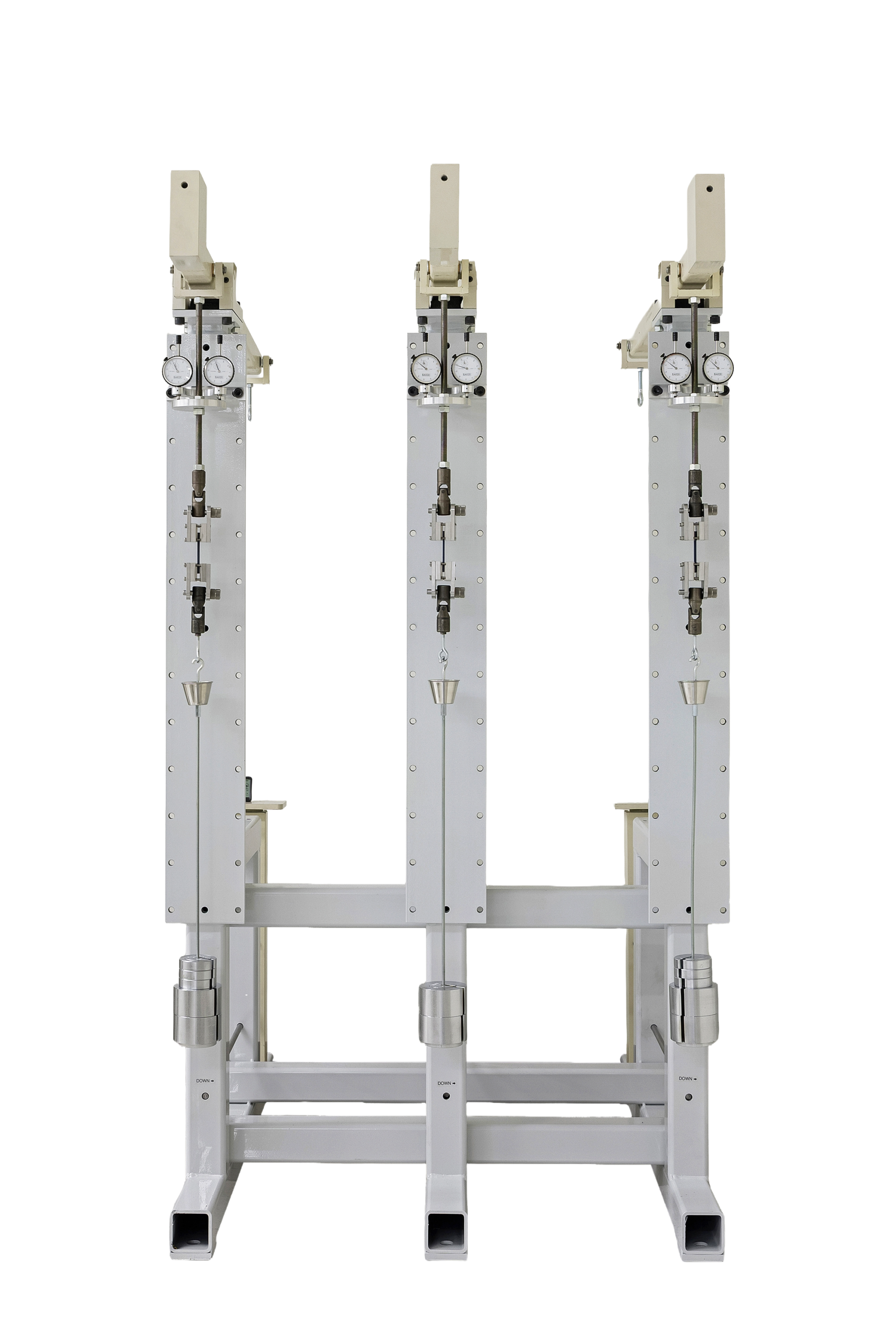 Three vertical testing machines with pressure gauges and adjustable components, designed for material testing and analysis in industrial applications.