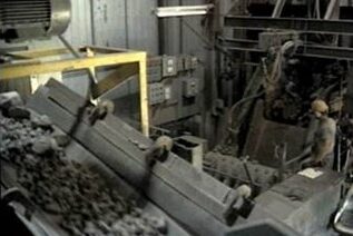 Industrial processing of natural flake graphite, showing machinery and workers in a production facility.