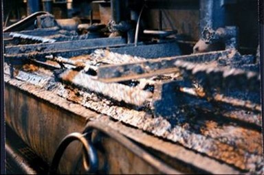Industrial processing of natural flake graphite, showing machinery and raw graphite material in a production setting.