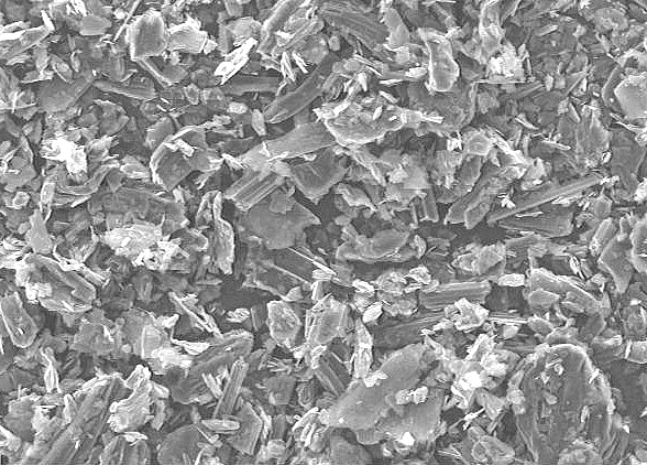 Microscopic view of crystalline mineral flakes, showcasing intricate textures and structures, ideal for mineralogy studies and material science analysis.
